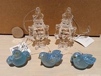 overview showing 2 clear nutcrackers and 3 blue bird ornaments