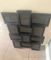 Front view of black collage frame showing 12 empty openings