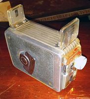 Kodak Brownie 8mm camera showing body, leatherette side, fold-up viewfinders