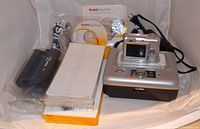 Full lot: camera, dock, power cord, cartridges, photo paper packs, software CD