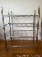 Front view showing four-tier metal wine rack