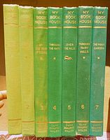 Seven green cloth hardcover books standing spine-out labelled My Book House volumes 1-7