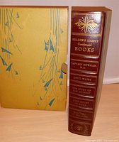 Slipcase alongside spine of book showing gilt title and list of included works
