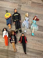 Group shot of all seven dolls laid on floor