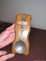 Front view of plaque with attached spoon