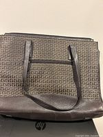 Front view of KGB brown monogram laptop shoulder bag