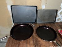 Front view showing both frying pans and both baking sheets
