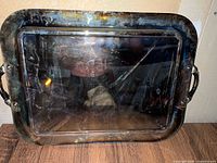 front view of silver-plated tray showing overall tarnish and scratches