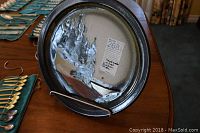 Back of a silver-toned decor plate with textured artistic finish, showing the edition number and signature label 54/70