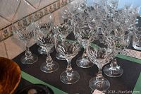 Eight crystal wine glasses arranged together showing etched cut design and clear appearance