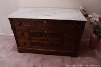 Front view of walnut finish dresser with white marble top showing overall condition and drawer arrangement