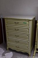 Front view of the yellow/cream painted Henry Link highboy dresser showing all drawers closed with metal handles.