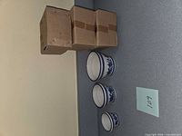 Boxed sets beside three sample planters showing design and size gradation
