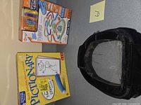 Group view of Pictionary game, Hexbug set and velvet case