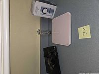 Shelf view of all four items: mosquito killer box, pink scale, glass candlestick, Sony player