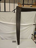 Full view of crosscut hand saw showing entire blade and handle