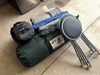 Overall lot with sleeping bags, tent bag, folding stools