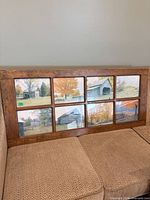 Full view of rectangular nine-pane wooden frame on sofa