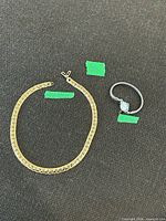 Necklace and wristwatch together for scale