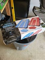Boxed EastPoint portable cornhole set showing product image of blue and red boards