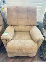 Front view of beige fabric manual recliner chair with button-tufted back and pillow arms