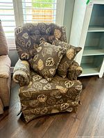 front view of upholstered chair with pillows
