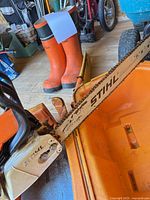 Stihl MS260 chainsaw and part of Viking boots visible