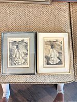Both framed etchings side by side