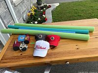 Lot overview showing 3 caps, 4 pool noodles, 5 koozies
