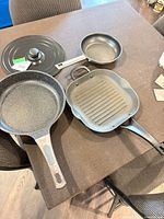 Overview of all four cookware pieces on table