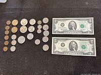 Overall view showing two $2 bills and grid of coins