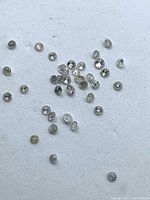 Scattered group of small round diamonds on white background