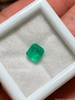 Loose square emerald cut gemstone in display box