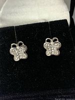 Front view of butterfly stud earrings in display box
