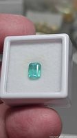 Top view of octagon-cut emerald in display box