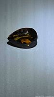 Front view of pear-cut Madeira citrine showing deep cognac color