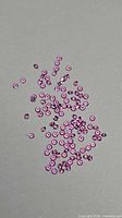Scattered group of small round pink sapphires