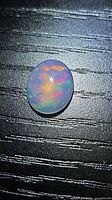 Top view of oval Ethiopian fire opal cabochon showing play-of-color