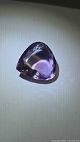 Front view of faceted purple amethyst pear