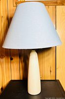 Full view of ceramic lamp with gray shade