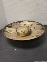 Top view of brass floral enamel bowl with box nested