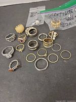 Group shot of all rings spread on surface including bagged items