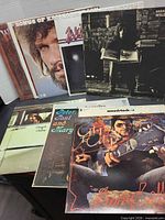Stacked view of several album covers showing Kristofferson, Rafferty, Woodstock, Peter Paul & Mary