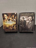 Front view of both Deadwood Season 1 and Season 2 DVD box sets
