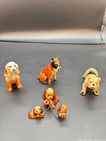 Group shot of all six porcelain dog figurines