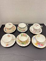 Group shot of six cup and saucer sets