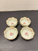 Four small Limoges floral bowls grouped