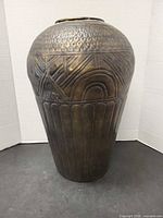 Full view of embossed metal vase front