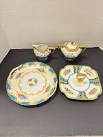Full view of four Noritake pieces