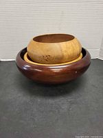 three wooden bowls nested